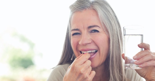 woman taking a sedation pill