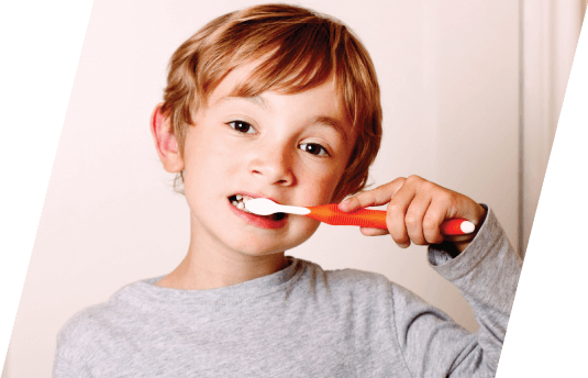 young boy brushing his teeth