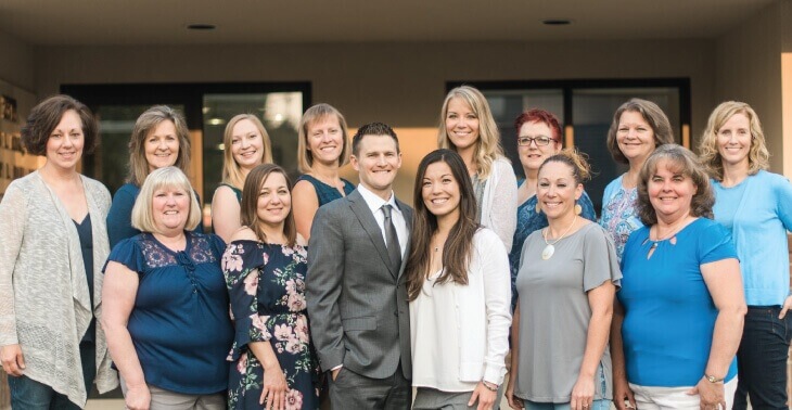 The Corvallis Dental Group team smiles in front of their Corvallis, OR dental office