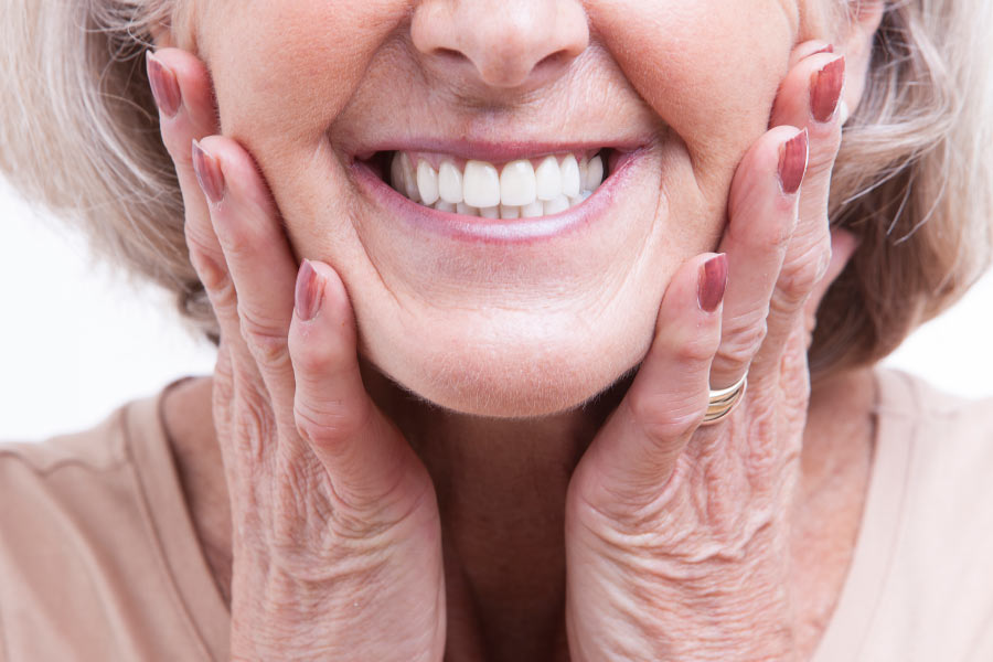 Close up of a mature woman smiling to show her beautiful new veneers.