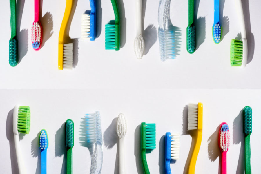 A display of multi-colored toothbrushes in various sizes.
