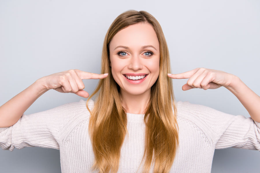 Smiling young woman with white teeth.