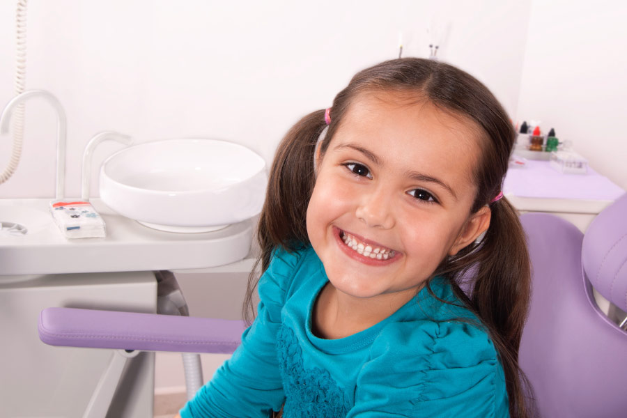 Smiling young girl at the dentist.