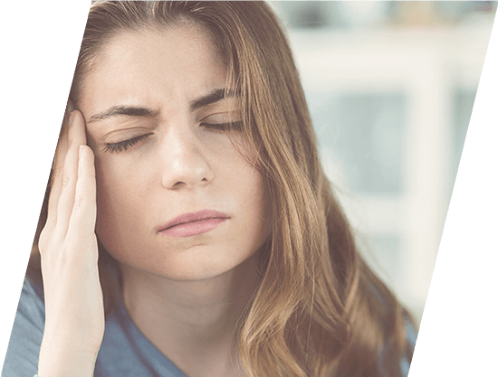 woman holding the side of her head in pain