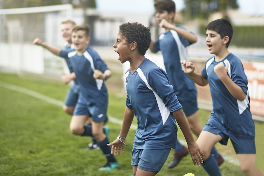 young men playing soccer wearing custom athletic mouthguards